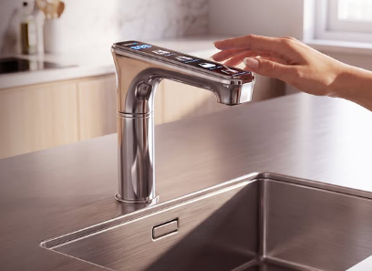 A hand using the So Safe Digital Faucet at a kitchen sink